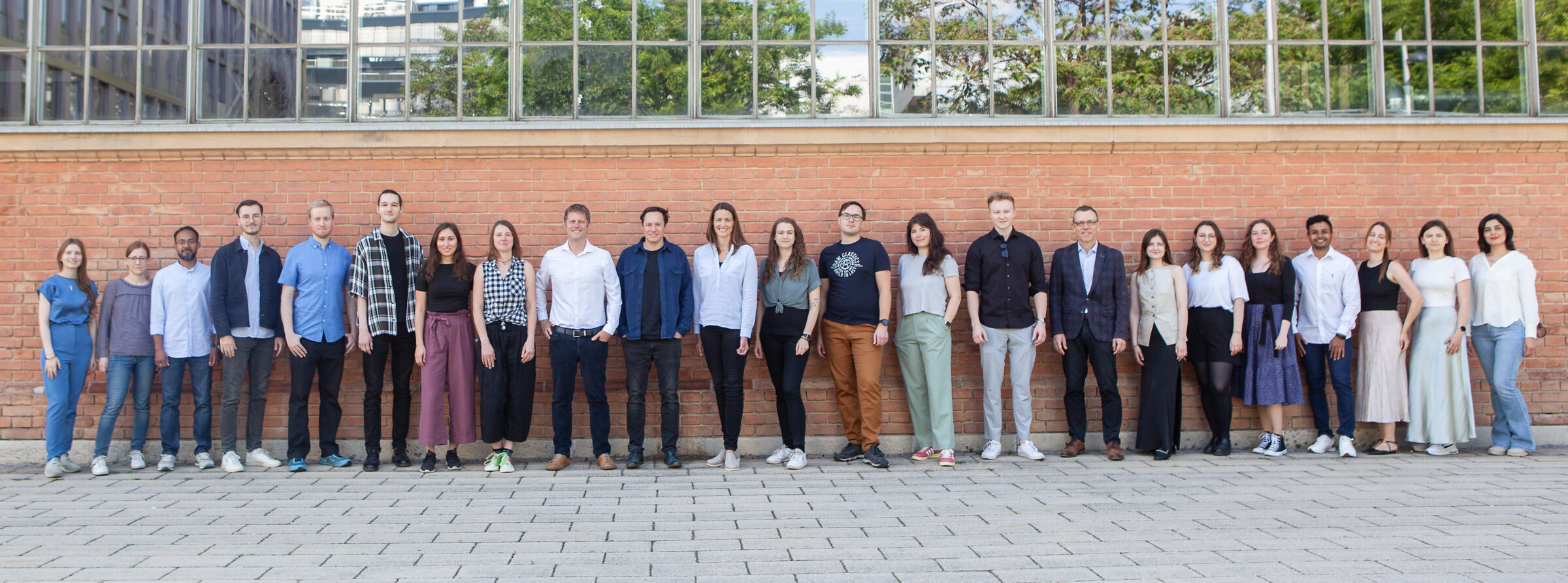 24-0178 The CRISPR screening team at Myllia Biotechnology GmbH in front of a brick wall in Vienna, Austria